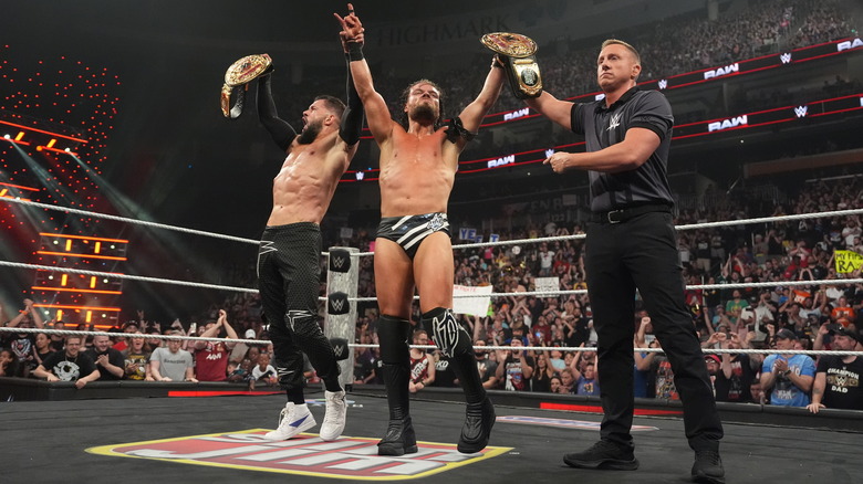 Finn Balor and JD McDonagh celebrate with the world tag titles on "WWE Raw"
