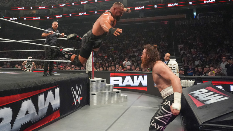 Bron Breakker leaps onto Sami Zayn standing beside the announce table on "WWE Raw"