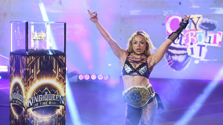 Liv Morgan poses next to the Queen of the Ring crown on "WWE Raw"