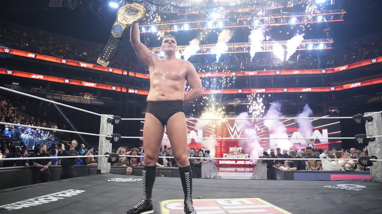GUNTHER holds up the World Heavyweight title belt on "WWE Raw"