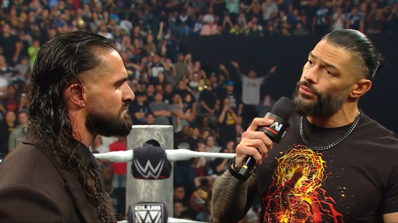 Roman Reigns exchanges words with Seth Rollins