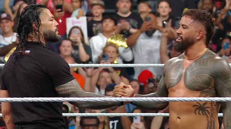 Roman Reigns and Jey Uso shake hands in the middle of the ring at the end of WWE Raw on July 14, 2025.