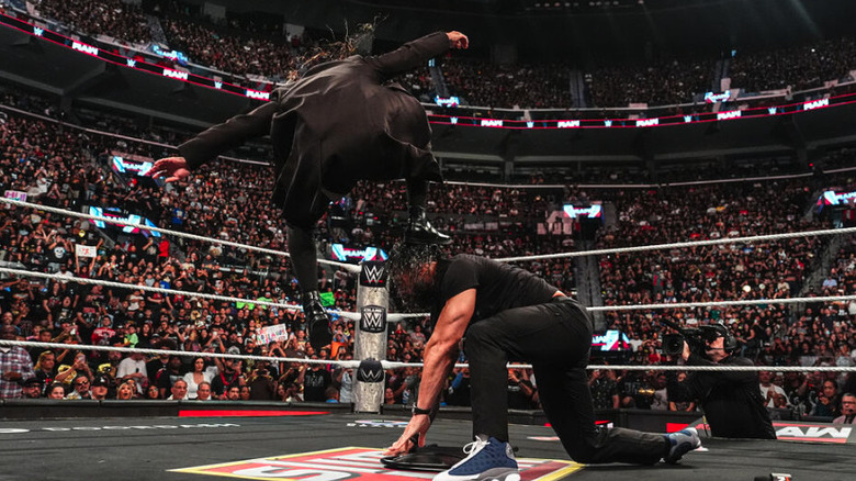 Seth Rollins stomps Roman Reigns into a steel chair on "WWE Raw"