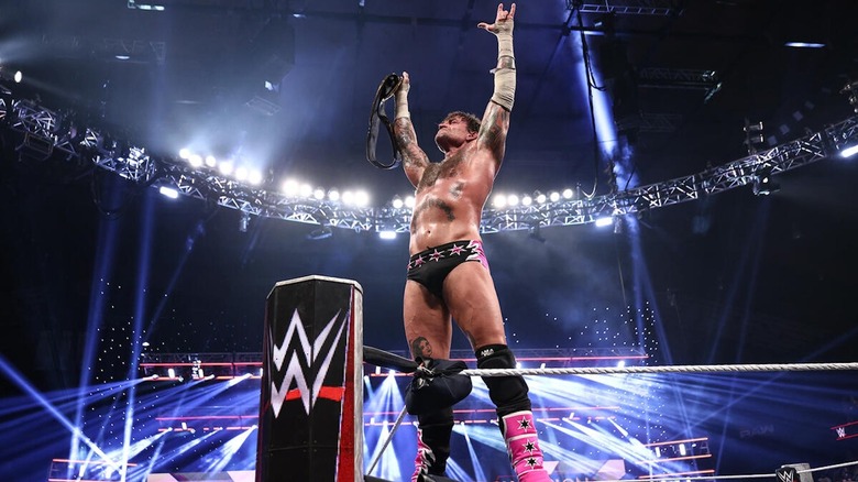 CM Punk stands tall holding the Undisputed WWE title on "WWE Raw"