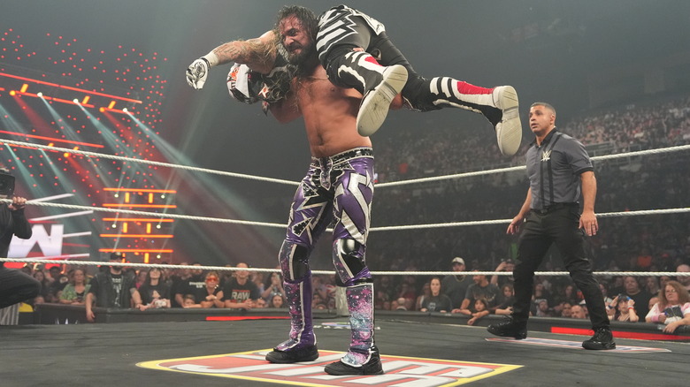 Seth Rollins with Penta on his shoulders on "WWE Raw"