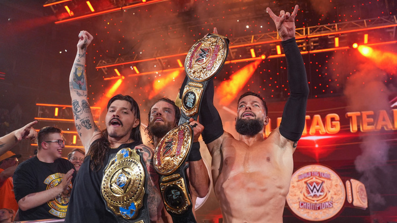 Finn Balor and JD McDonagh (Judgment Day) celebrate becoming the World Tag Team Champions with Dominik Mysterio during Monday Night RAW at PPG PAINTS Arena on June 30, 2025 in Pittsburgh, Pennsylvania.