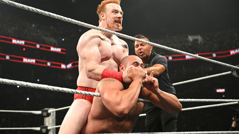 Sheamus pins Rusev against the middle rope and attempts to choke him.