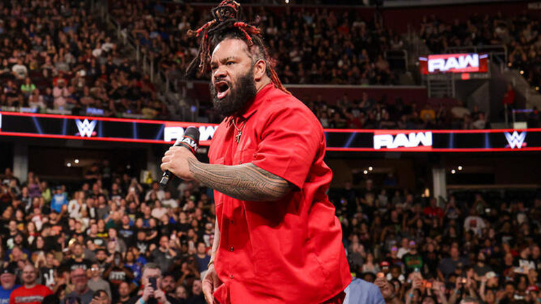 Jacob Fatu with a microphone outside the ring on "WWE Raw"