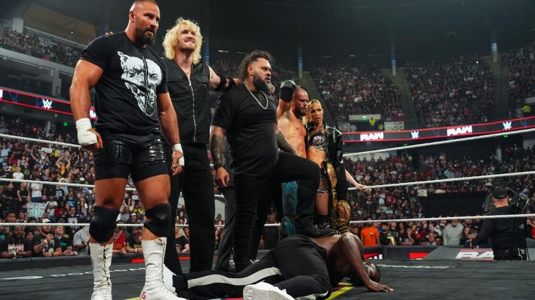 Bron Breakker, Logan Paul, Bron Breakker, with his foot on top of Oba Femi, Austin Theory, and Maxxine Dupri stan over the fallen "Ruler" in the middle of the ring on the September 7, 2026 edition of "WWE Raw."