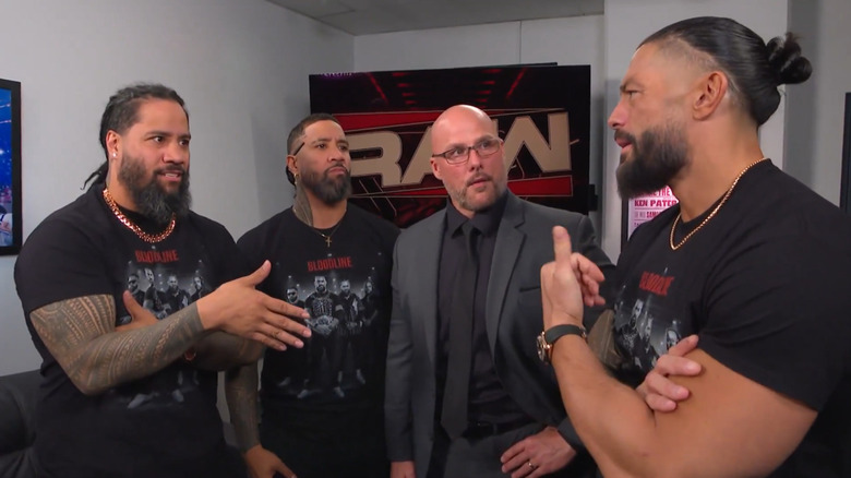 Roman Reigns, the Usos and Adam Pearce backstage