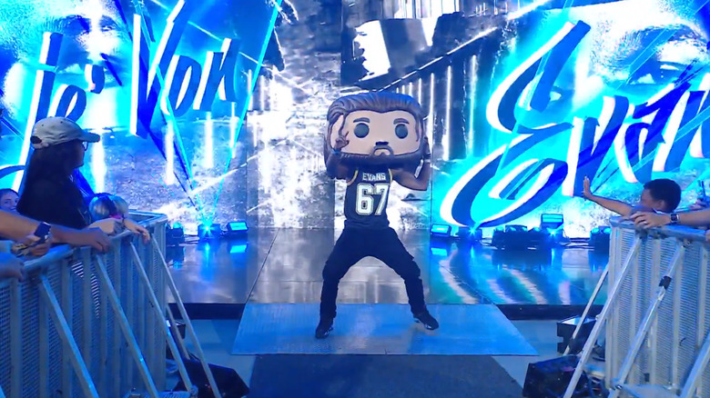 Je'Von Evans appears on the stage, wearing a giant head made to look like a JD McDonagh Funko Pop figure, during the September 7, 2026 edition of "WWE Raw."