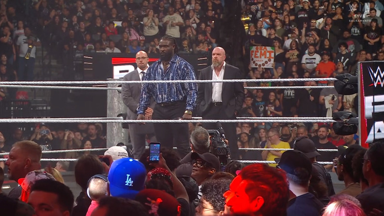 Femi, Pearce, and Triple H in the ring