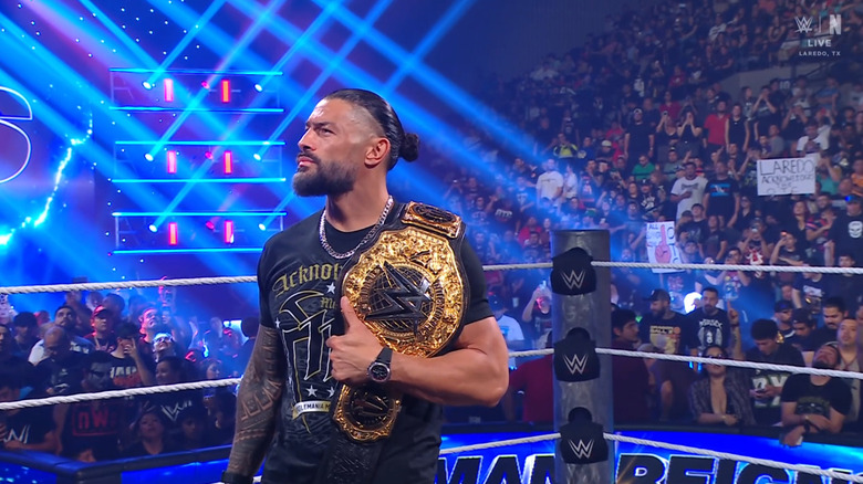 Reigns in the ring with his World Heavyweight Championship