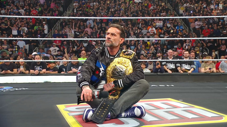 Punk sitting cross legged in the ring