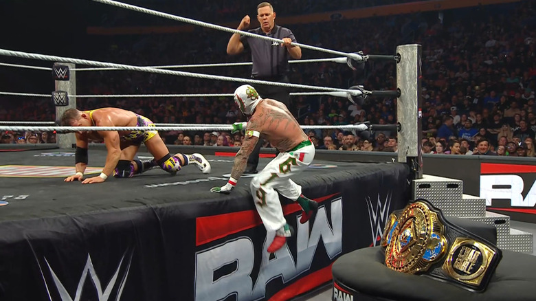 Gable and Rey near the ring apron with the Intercontinental Championship belt in focus