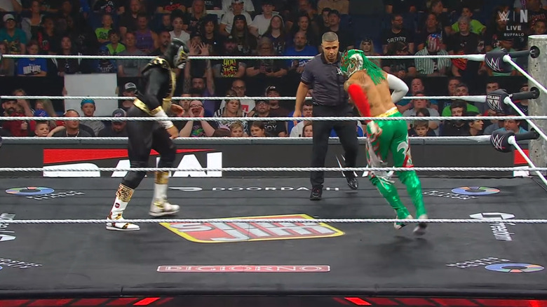 Fiscal and Fenix staring down one another in the ring