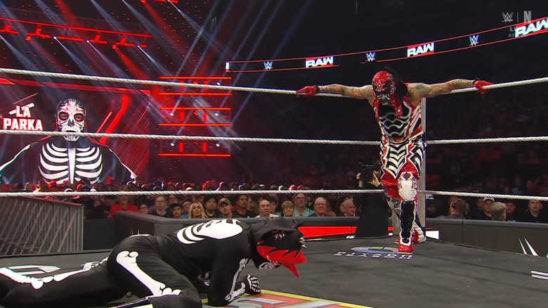 Penta standing over Parka in the ring