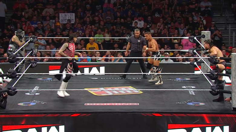 All four men inside and around the ring