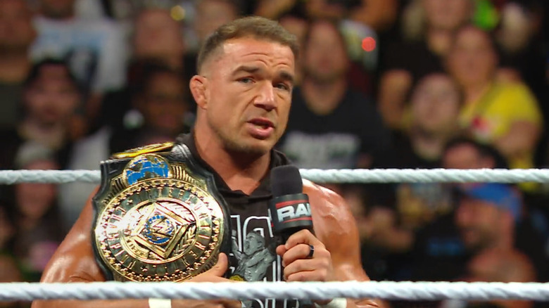 Gable speaking in the ring with his Intercontinental Championship in hand