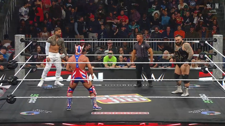 All three men staring one another down in the ring