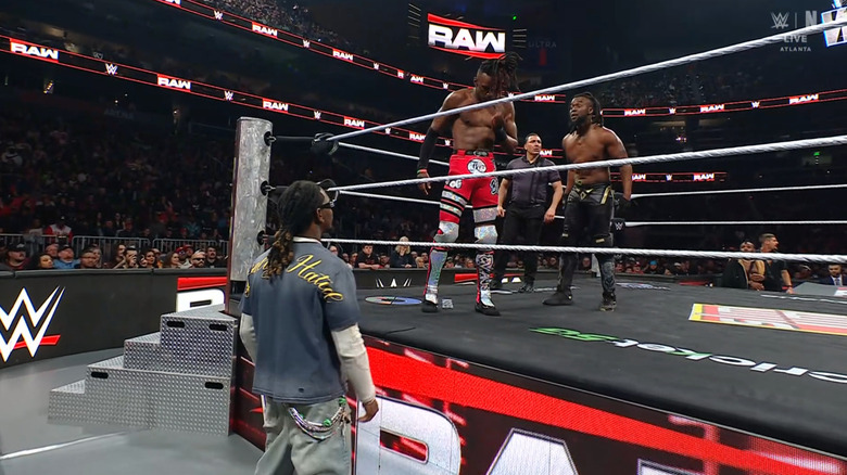 Evans and Kingston in the ring as Offset stands on the outside