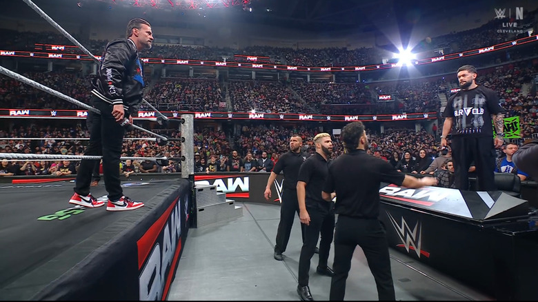 Punk and Balor staring one another down