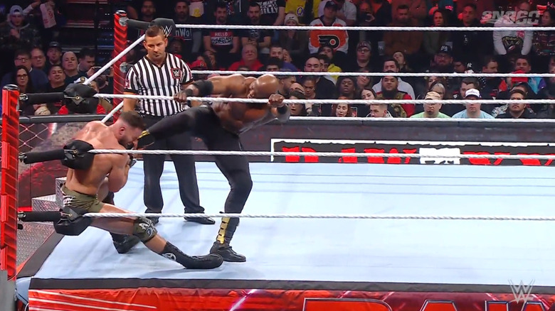 Lashley sending Theory into the corner. 