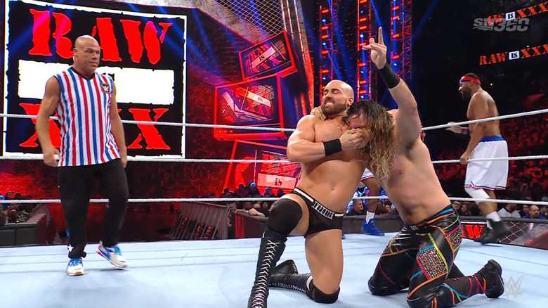 Vinci with a headlock on Rollins