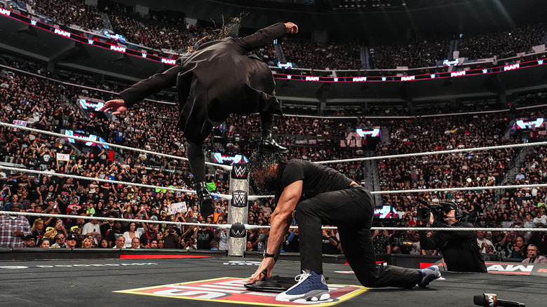 Seth Rollins stomps Roman Reigns into a steel chair on "WWE Raw"