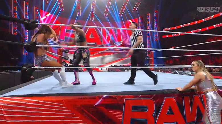 Belair and Asuka in the ring as Green watches on 