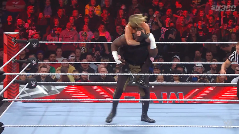 Ziggler with a Sleeper on Omos