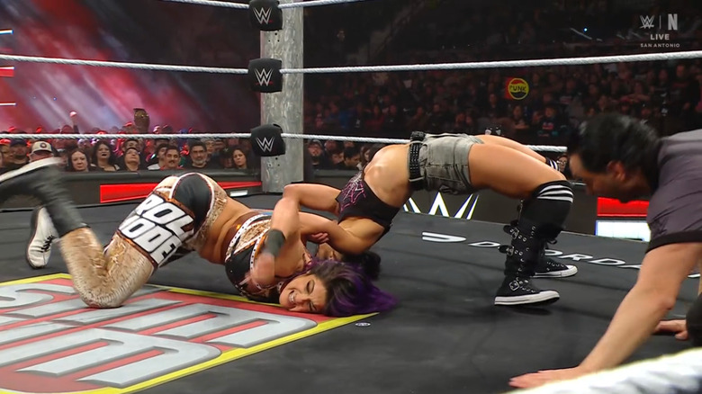 Lee with a Bridging Hammerlock cinched in on Bayley
