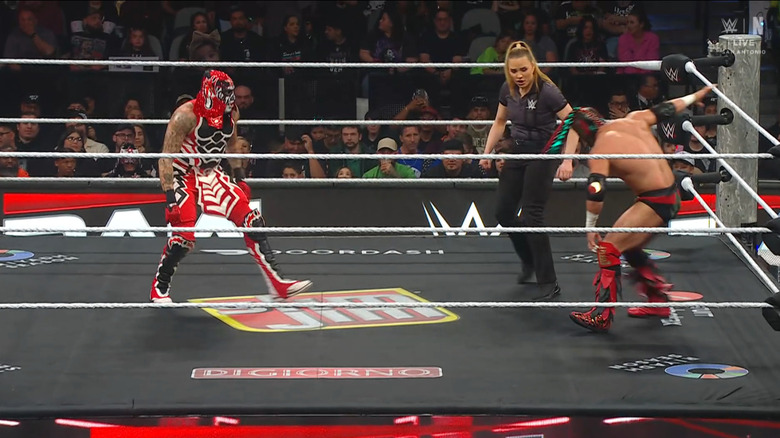 Penta and Lee staring down one another in the ring