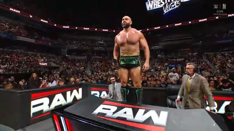 Rusev standing on top of the announce desk