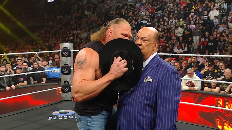 Lesnar whispering something to Heyman