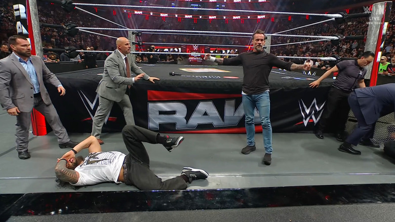 Reigns, Pearce, Punk, and other officials at ringside