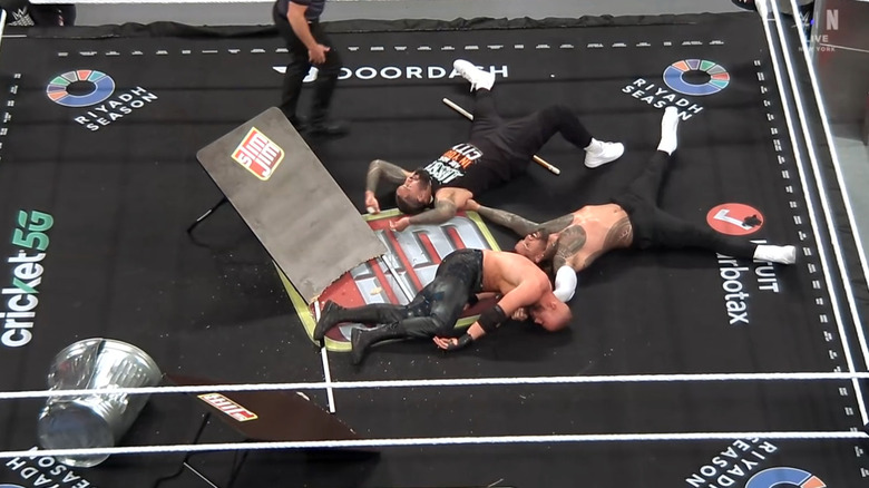The Usos having sent Theory crashing through a table with a superplex