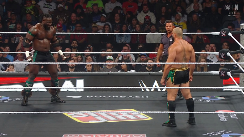 Femi and Rusev staring one another down in the ring