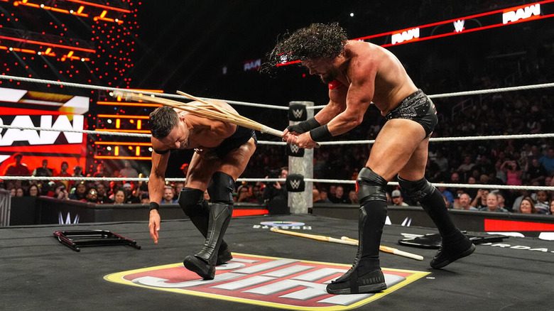 JD McDonagh breaks a kendo stick over the shoulder of Finn Balor on "WWE Raw"