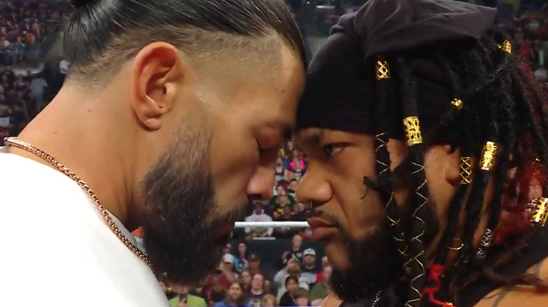 Roman Reigns and Jacob Fatu face off in the ring
