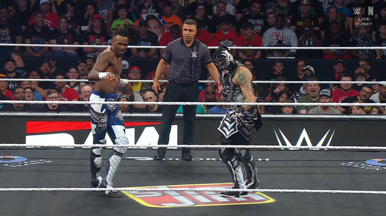 Evans and Penta performing Penta's signature walk in the ring