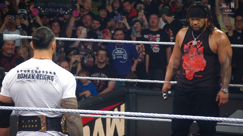 Reigns and Fatu both in the ring staring one another down