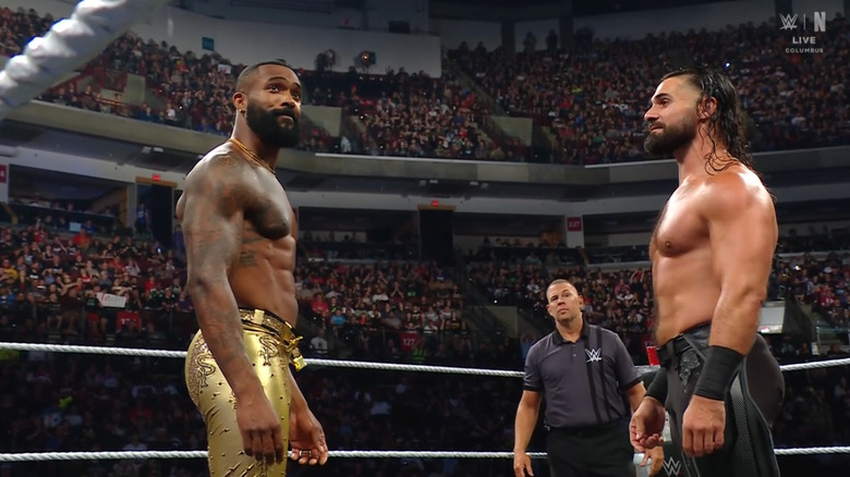 Ford and Rollins staring down one another in the ring