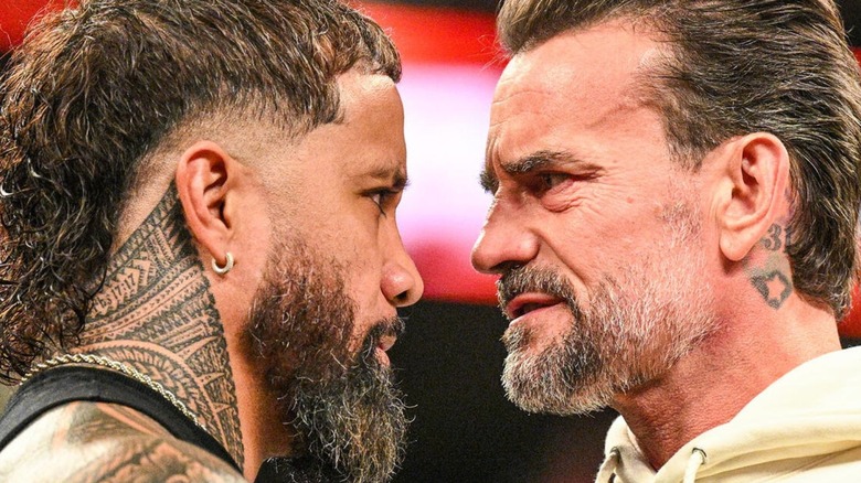 Jey Uso and CM Punk stare each other down in the middle of the ring during an episode of 