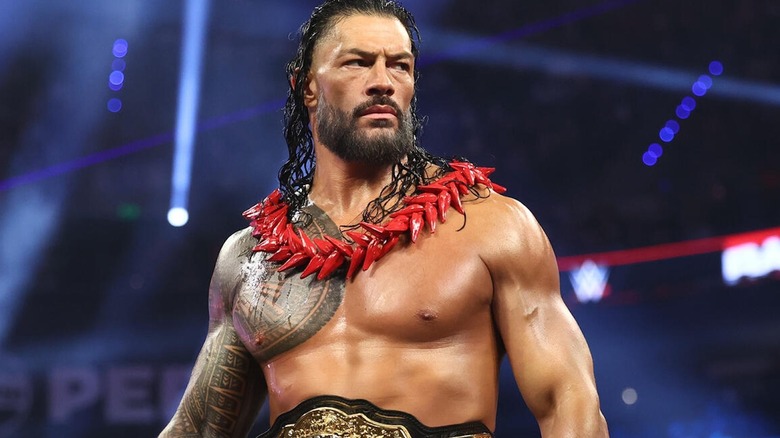 Roman Reigns wearing an Ula Fala and the world title on 