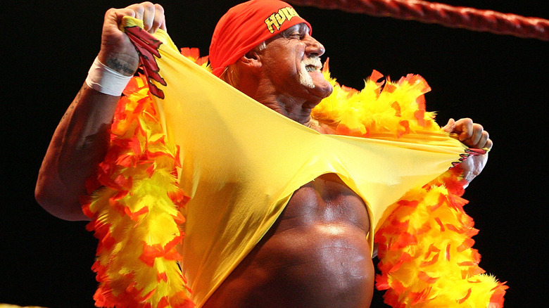 Hulk Hogan rips open his iconic yellow shirt during his entrance.