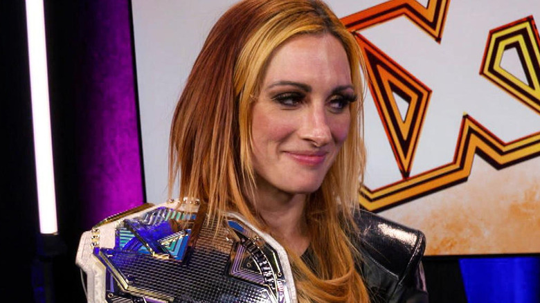 Becky Lynch with the "NXT" Women's Championship on her shoulder