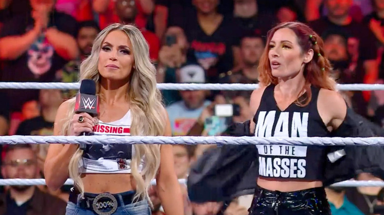 Becky Lynch standing behind Trish Stratus