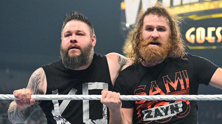 Kevin Owens and Sami Zayn holding onto the top rope in WWE