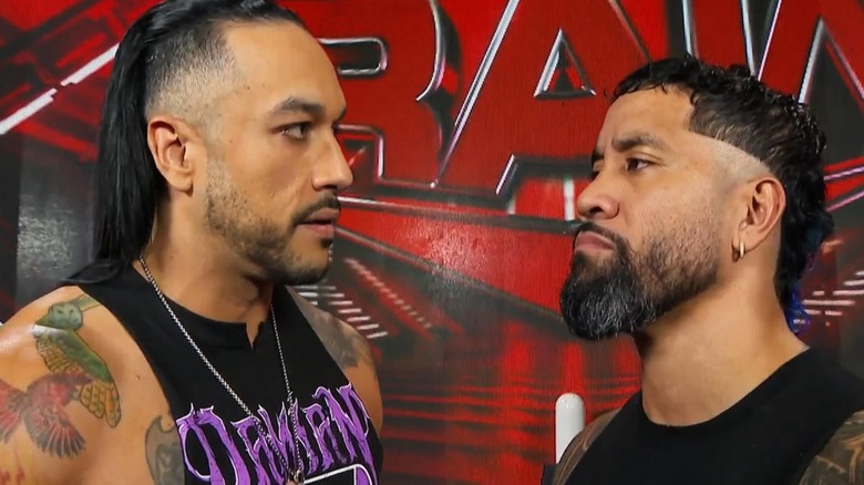 Damian Priest and Jey Uso staring